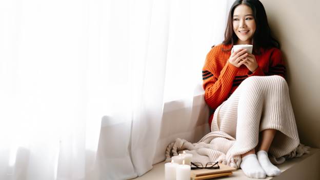 A person sitting on the floor with a cup of coffee AI-generated content may be incorrect.